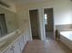 Bathroom featuring a vanity, tub, and tile flooring at 4576 Creek Forestt Trl, Lilburn, GA 30047
