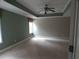 Carpeted bedroom is spacious with a ceiling fan and windows at 4576 Creek Forestt Trl, Lilburn, GA 30047