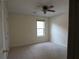 Cozy bedroom with a ceiling fan, carpeted floors, and natural light at 4576 Creek Forestt Trl, Lilburn, GA 30047