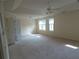 Carpeted bedroom is spacious with a ceiling fan and windows at 4576 Creek Forestt Trl, Lilburn, GA 30047