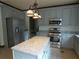 Well-equipped kitchen featuring stainless steel appliances, granite countertops, and an island at 4576 Creek Forestt Trl, Lilburn, GA 30047