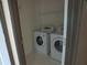 Laundry room features a washer and dryer with tile floors at 4576 Creek Forestt Trl, Lilburn, GA 30047