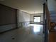 Spacious living room featuring tile floors, large windows, and staircase access at 4576 Creek Forestt Trl, Lilburn, GA 30047