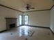 Open living area featuring a stone fireplace, neutral walls, and tiled floors at 4576 Creek Forestt Trl, Lilburn, GA 30047