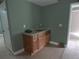 Wet bar features wooden cabinets, a sink, and granite counters at 4576 Creek Forestt Trl, Lilburn, GA 30047