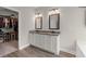 Bathroom features dual sinks, granite counters, wood-look floors, and entry to the walk-in closet at 65 Harmony Woods Ln, Dallas, GA 30157
