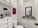 Powder room with white cabinets, granite counters, decorative accents, and modern fixtures at 65 Harmony Woods Ln, Dallas, GA 30157