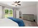 Bright carpeted bedroom offers a backyard view and features a large dresser at 65 Harmony Woods Ln, Dallas, GA 30157