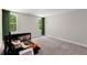 Spacious bonus room with natural light, green curtains, and potential as a versatile living area at 65 Harmony Woods Ln, Dallas, GA 30157
