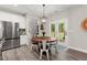 Bright eat-in kitchen featuring stainless steel appliances, a wood table with seating and access to the outdoors at 65 Harmony Woods Ln, Dallas, GA 30157