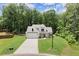 Beautiful new construction home featuring a white exterior, large front lawn, and attached two car garage at 65 Harmony Woods Ln, Dallas, GA 30157