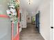 Bright foyer with wood-look flooring, decorative wreath, and a view into the adjoining living spaces at 65 Harmony Woods Ln, Dallas, GA 30157