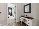 Hallway with hardwood floors features a quaint desk and leads to a bedroom with blue accent wall at 65 Harmony Woods Ln, Dallas, GA 30157