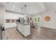 Bright kitchen features white cabinetry, stainless steel appliances, granite countertops, and an island with bar stool seating at 65 Harmony Woods Ln, Dallas, GA 30157