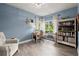 Cozy office space with blue walls, natural light, and built-in shelving for organized storage at 65 Harmony Woods Ln, Dallas, GA 30157