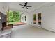 Covered back patio with a stone fireplace and view of the green backyard at 65 Harmony Woods Ln, Dallas, GA 30157