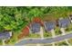 Overhead view of a house featuring landscaping, a driveway, and a backdrop of mature trees at 1916 River Birch Ln, Atlanta, GA 30316