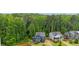 A picturesque aerial view of a blue home nestled among lush trees in a well-maintained neighborhood at 1916 River Birch Ln, Atlanta, GA 30316