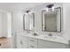 Stylish bathroom with double vanity, elegant lighting, and decorative wallpaper at 1916 River Birch Ln, Atlanta, GA 30316