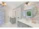 Stylish bathroom featuring double vanity, unique wallpaper, and a soaking tub with a view at 1916 River Birch Ln, Atlanta, GA 30316