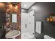 Stylish half-bathroom with floral wallpaper, pedestal sink, and subway tiled walk-in shower at 1916 River Birch Ln, Atlanta, GA 30316