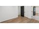 Spacious bedroom with an open doorway showcasing beautiful hardwood floors at 1916 River Birch Ln, Atlanta, GA 30316