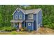 Charming two-story home featuring board and batten siding, a covered front porch and a neatly landscaped yard at 1916 River Birch Ln, Atlanta, GA 30316