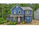Charming blue two-story home with inviting front porch and colorful rocking chairs at 1916 River Birch Ln, Atlanta, GA 30316