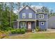 Charming two-story home featuring a pink door and inviting front porch with seating at 1916 River Birch Ln, Atlanta, GA 30316