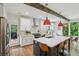 Modern kitchen with stainless steel appliances, large island with seating, and eat-in dining area at 1916 River Birch Ln, Atlanta, GA 30316