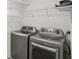 Laundry area with modern washer and dryer and wire shelving for storage at 1916 River Birch Ln, Atlanta, GA 30316