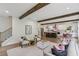 Open-concept living room featuring exposed wood beams and flowing into a bright, modern kitchen at 1916 River Birch Ln, Atlanta, GA 30316
