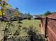 Spacious, well-maintained backyard with lush green grass, defined garden beds, and a wooden fence at 2030 Hydrangea Ln, Austell, GA 30106