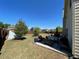 Backyard features a cozy patio setup with seating, a grill, and a view of the spacious, well-maintained lawn at 2030 Hydrangea Ln, Austell, GA 30106