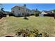 Expansive backyard featuring a lush lawn, mature trees, defined garden beds, and partial fencing for privacy at 2030 Hydrangea Ln, Austell, GA 30106