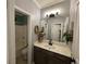 Bathroom with a gray vanity with gold accents, mirror, and a combined bathtub and shower at 2030 Hydrangea Ln, Austell, GA 30106