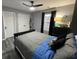 Bedroom featuring gray walls, a ceiling fan, a dresser, and wood-look laminate flooring at 2030 Hydrangea Ln, Austell, GA 30106