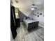 Bedroom with gray walls with geometric design, ceiling fan and light, and wood-look laminate flooring at 2030 Hydrangea Ln, Austell, GA 30106
