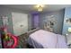 Bright bedroom featuring a decorative light fixture, gray walls, and wood-look laminate flooring at 2030 Hydrangea Ln, Austell, GA 30106