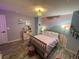 room with a mauve bed, colorful wall mural and wood-look floors under a decorative light at 2030 Hydrangea Ln, Austell, GA 30106