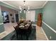 Elegant dining room with modern lighting, a dark wood table, and inviting decor at 2030 Hydrangea Ln, Austell, GA 30106