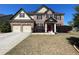 Beautiful two-story brick home with a well-kept lawn, two-car garage, and inviting front entrance at 2030 Hydrangea Ln, Austell, GA 30106