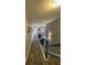 Upstairs hallway featuring hardwood floors, elegant lighting, and neutral wall colors at 2030 Hydrangea Ln, Austell, GA 30106