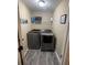 Functional laundry room with modern washer and dryer, and convenient shelving at 2030 Hydrangea Ln, Austell, GA 30106