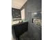 Stylish shower includes unique tiling, built in niche, and glass door with matte black trim at 2030 Hydrangea Ln, Austell, GA 30106