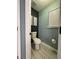 A private toilet room with a stand alone toilet paper holder and light blue paint at 2030 Hydrangea Ln, Austell, GA 30106