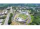 Aerial view of a community park with walking paths and a splash pad surrounded by greenery at 3621 Portland Trail Dr, Suwanee, GA 30024