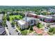 Aerial view of community center with a clock tower, surrounded by green space and neighborhood at 3621 Portland Trail Dr, Suwanee, GA 30024