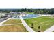Scenic aerial view of a public park featuring a pond, walking paths, and manicured lawns at 3621 Portland Trail Dr, Suwanee, GA 30024
