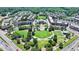 Community aerial view showcases a central park, mixed-use buildings, and tree-lined streets at 3621 Portland Trail Dr, Suwanee, GA 30024
